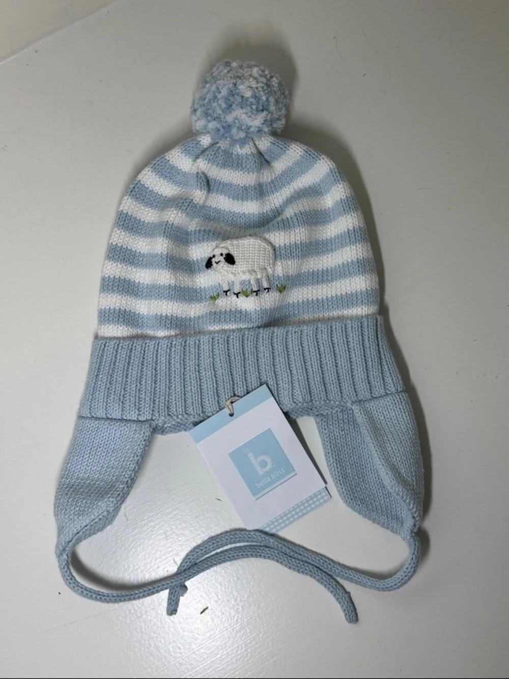 NWT Bella Bliss blue and white cotton child’s hat with ear flaps and ties.